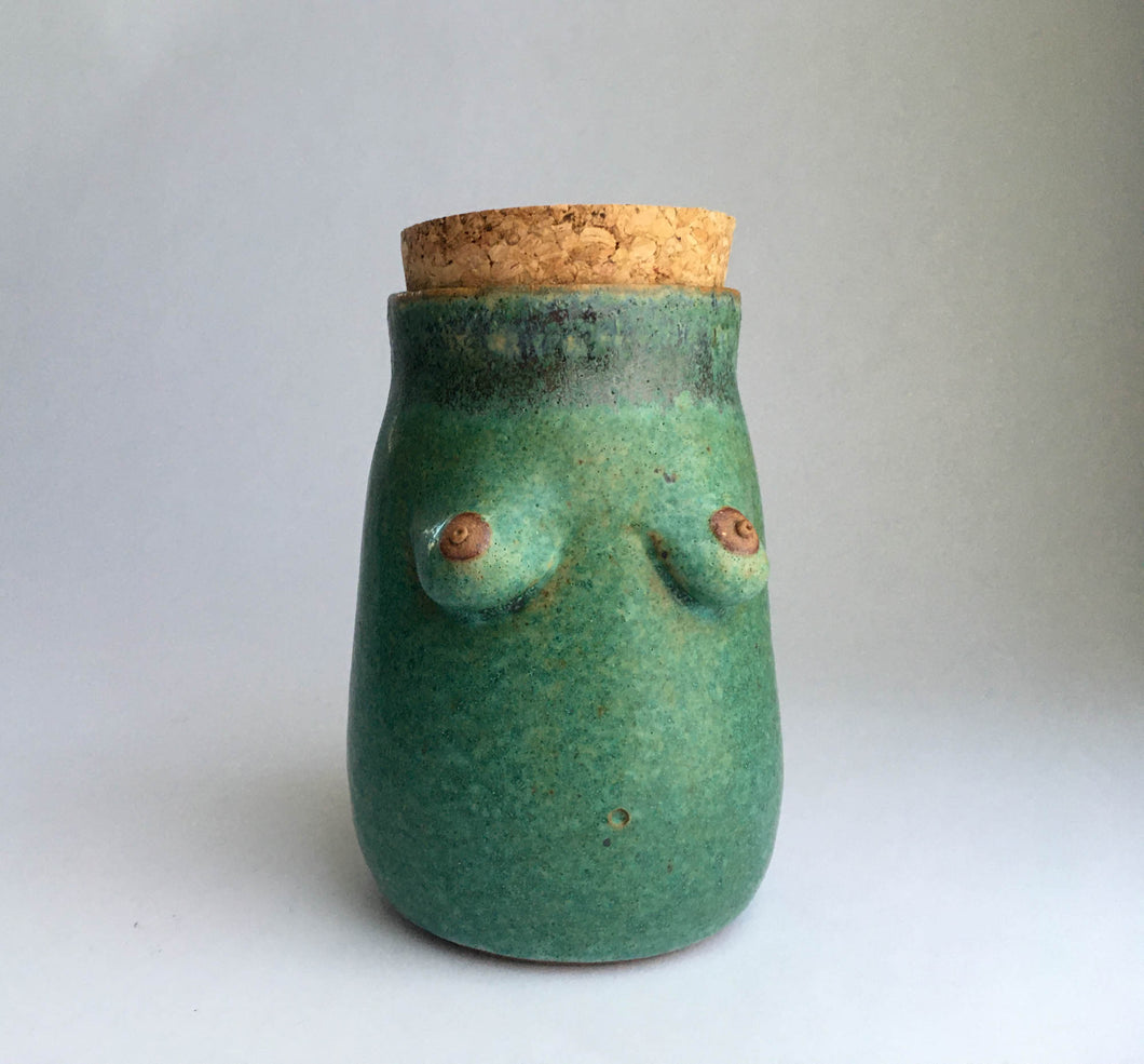 Green pottery jar with 2 inch wide cork stopper.